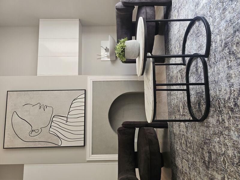 Therapy room with comfortable armchairs and calming artwork